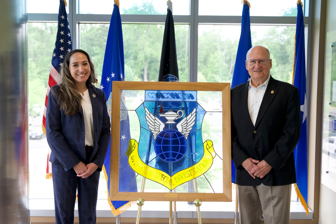 Pearl Mundt, OSI's executive director, meets with Charles Torpy, the agency's first executive director, at OSI's headquarters in Quantico, Virginia.