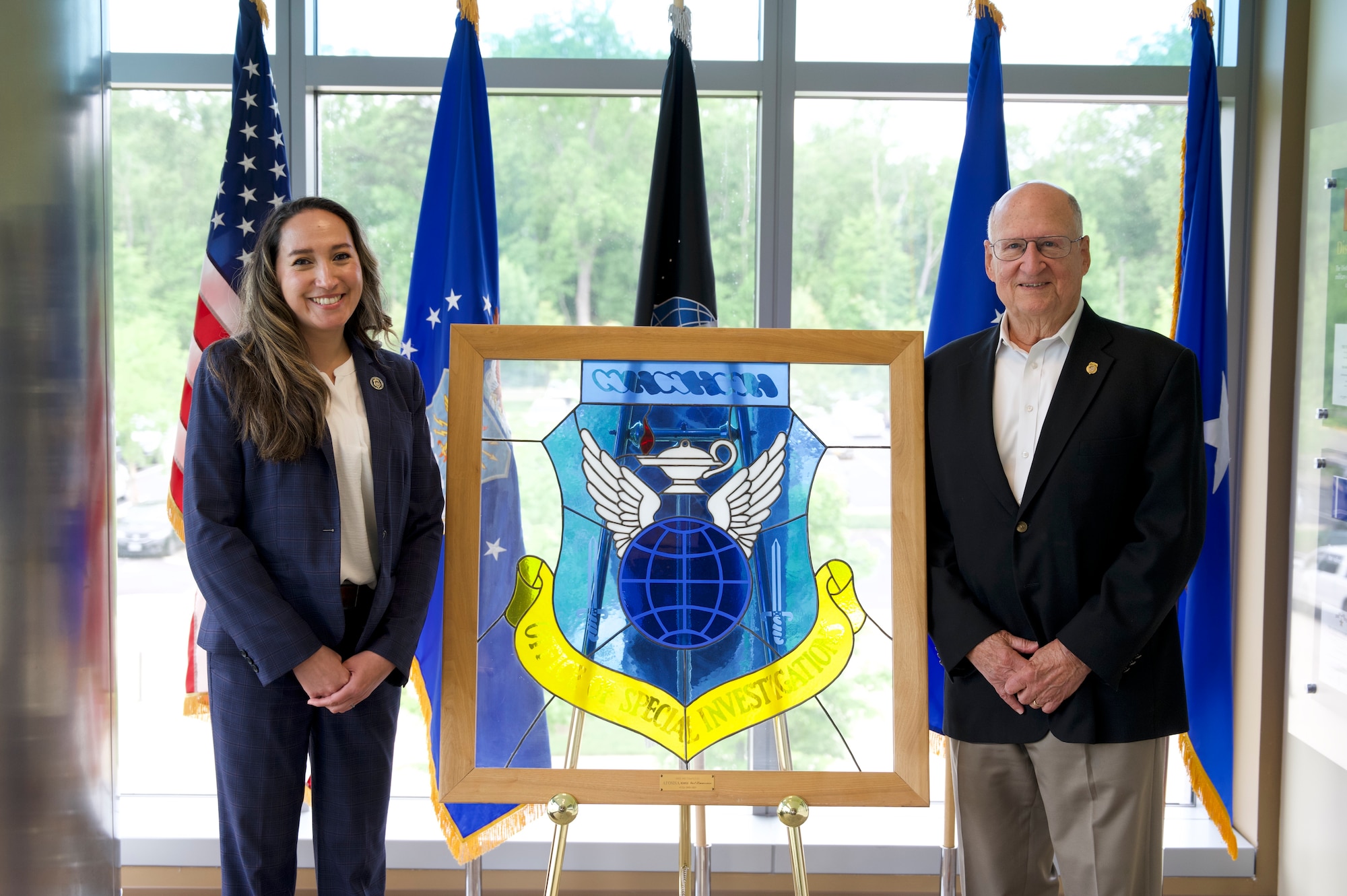 Pearl Mundt, OSI's executive director, meets with Charles Torpy, the agency's first executive director, at OSI's headquarters in Quantico, Virginia.