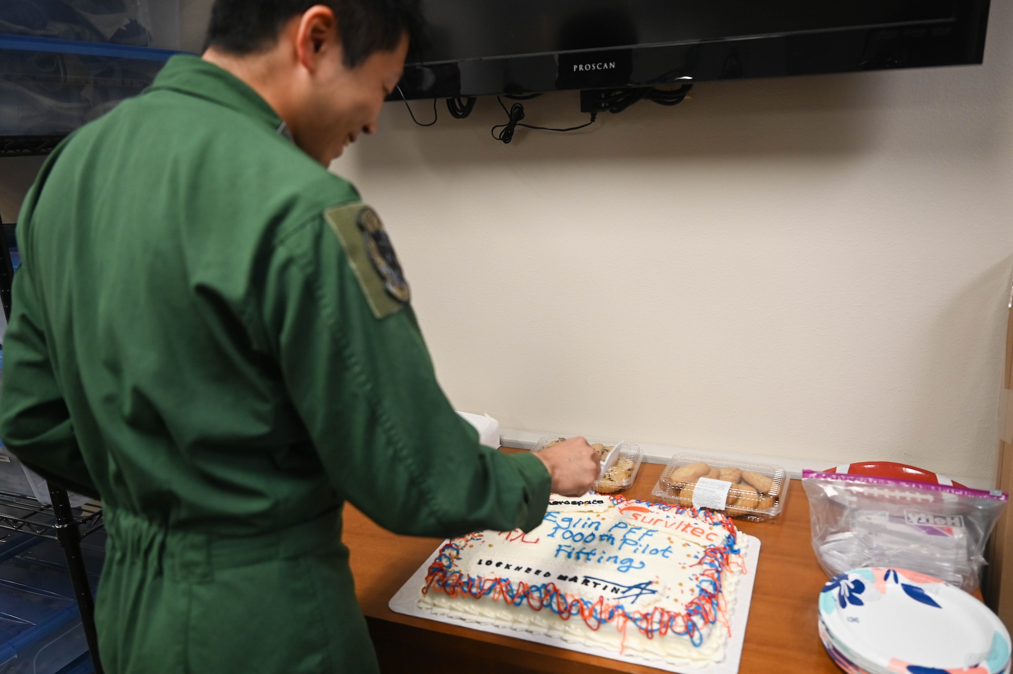 Capt. Ryosuke Sugimoto, a Japanese Air Self-Defense Force F-35 Lightning II pilot, cuts a celebratory cake alongside the pilot fit facility team, Joint Program Office representatives, 33rd Fighter Wing leadership on May 22, 2024.