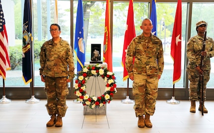 New York Army National Guard Brig Gen. Isabel Smith, the director of joint staff, and Command Sgt. Major Curtis Moss stand at attention during the playing of taps after placing a wreath at the New York National Guard headquarters Memorial Day ceremony in Latham, New York, May 23, 2024. The first Memorial Day, or Decoration Day as it was called after the Civil War, was held in New York.