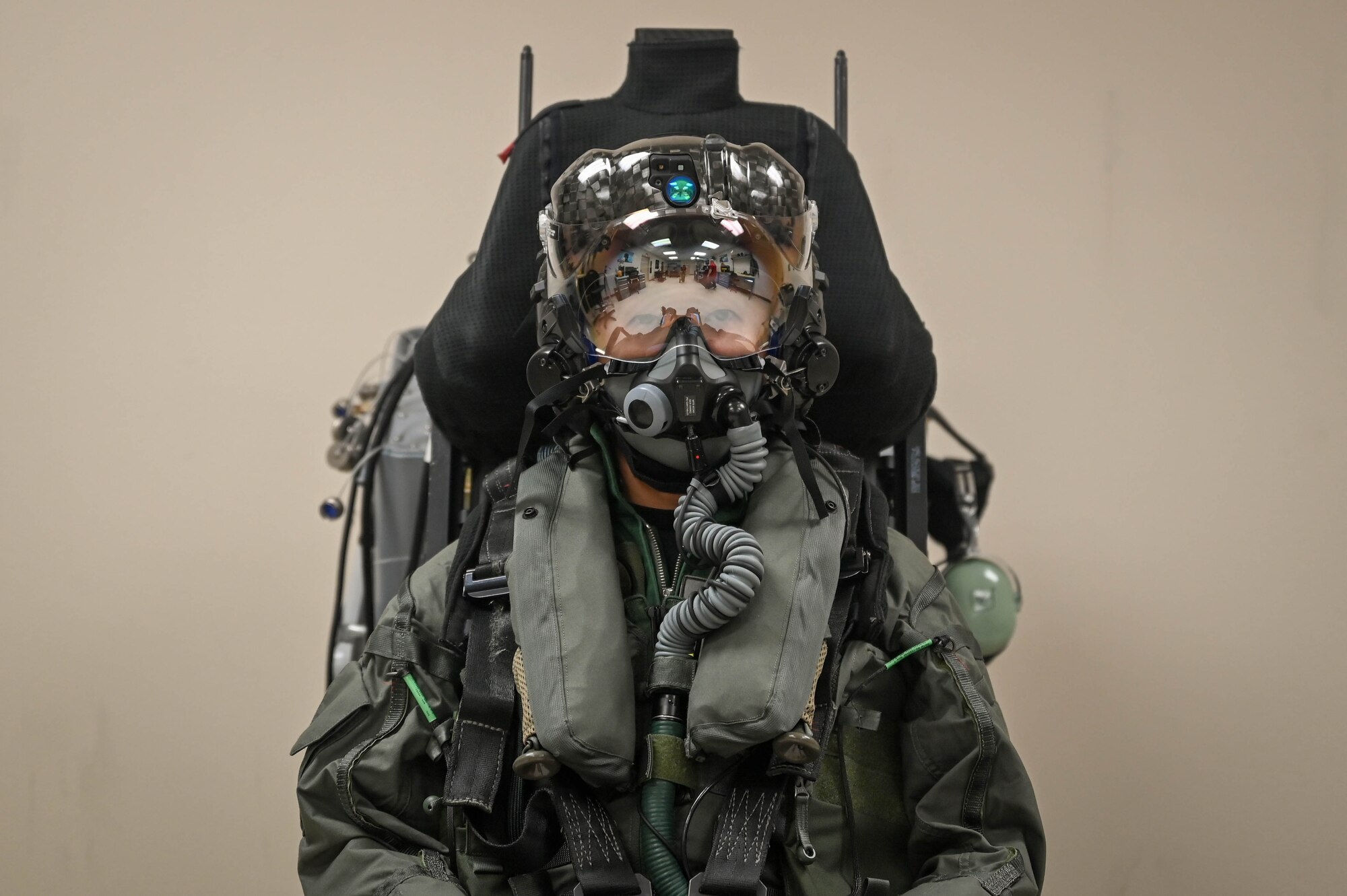 Capt. Ryosuke Sugimoto, a Japanese Air Self-Defense Force F-35 Lightning II pilot, sits in an ejection seat wearing his new pilot gear after completing the 1,000th fitting at the pilot fit facility on May 22, 2024