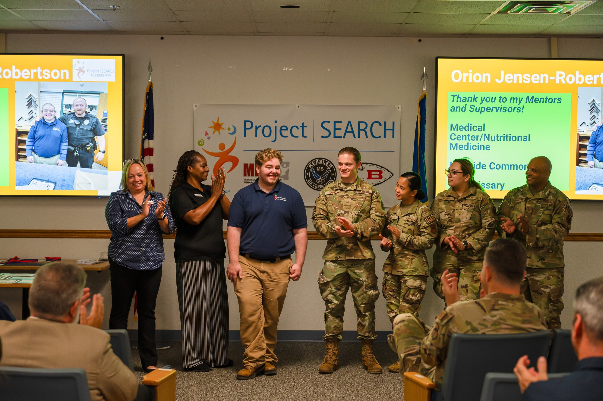 Orion Jensen-Robertson, Project SEARCH intern, stands beside family and mentors as he is recognized during the Project SEARCH graduation on Keesler Air Force Base, Mississippi, May 21, 2024.