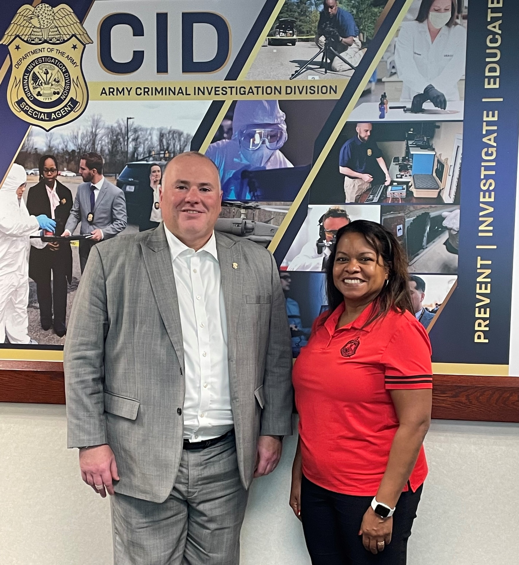 Army Criminal Investigation Division Director and the General Counsel of the Army stand before a CID sign.
