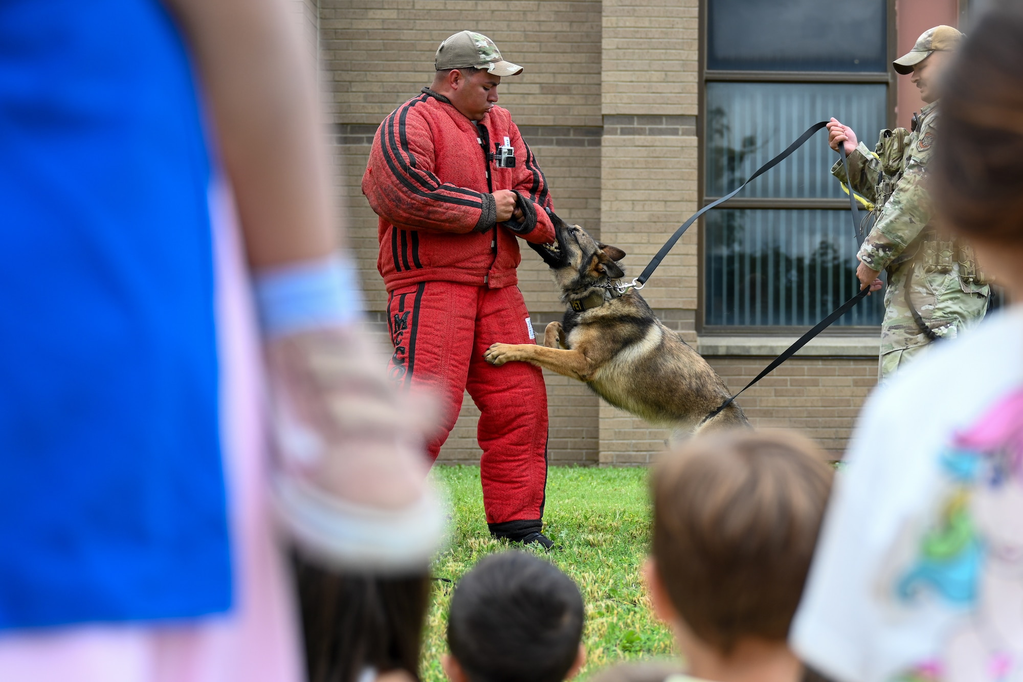 Staff Sgt. Joshua Espinoza, 22nd Security Forces Squadron kennel master, takes part in a K-9 demonstration for National Police Week May 16, 2024, at McConnell Air Force Base, Kansas. Police Week is an observance that pays tribute to the local, state and federal officers who have died or been disabled in the line of duty.