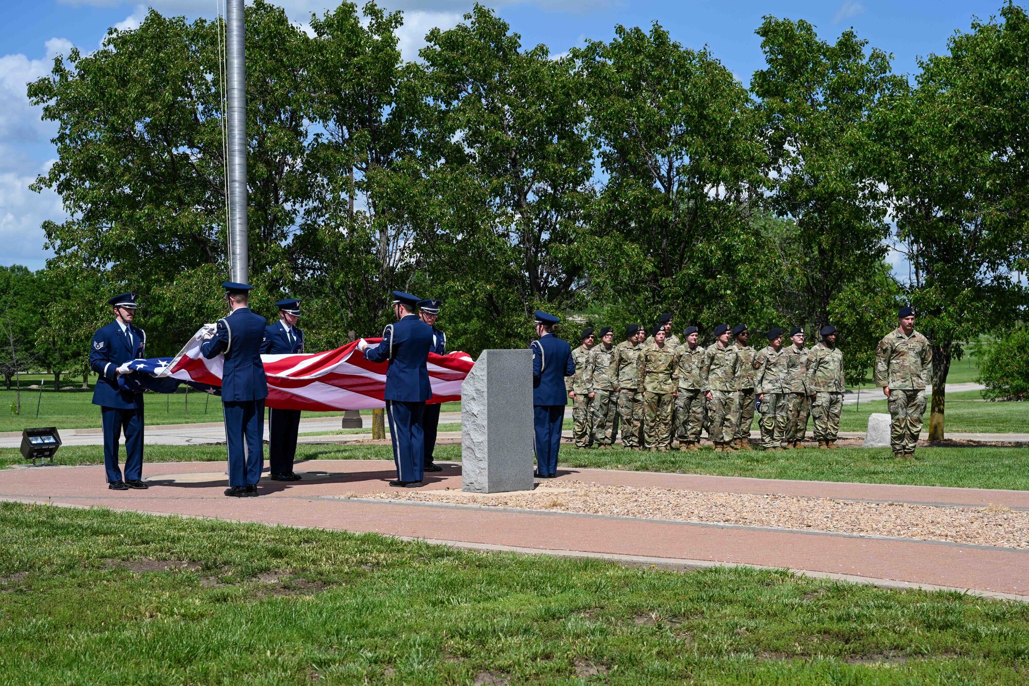 Honor guardsmen from 22nd Air Refueling Wing fold the U.S. flag during a closing ceremony for National Police Week May 17, 2024, at McConnell Air Force Base, Kansas. Police Week is an observance that pays tribute to the local, state and federal officers who have died or been disabled in the line of duty.