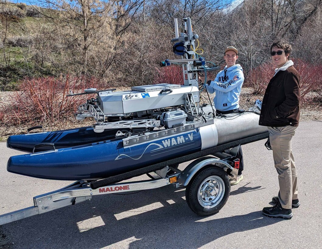 Brigham Young University Naval Engineering Education Consortium (NEEC) students preparing an unmanned surface vessel (USV) for field testing. This NEEC project is developing techniques to enable teams of unmanned underwater vehicles to cooperatively maintain an accurate, location estimate while operating for long periods of time in submerged scenarios. (courtesy photo)