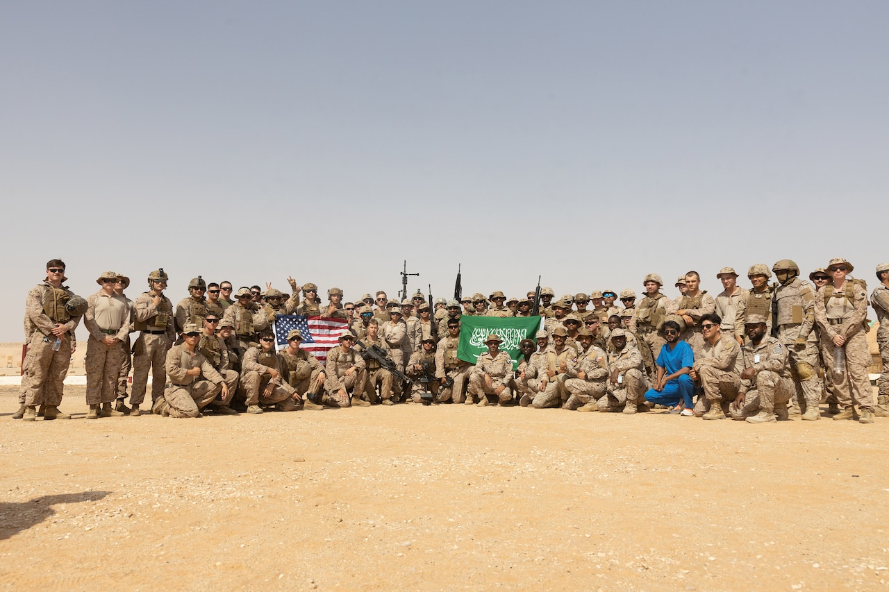 U.S. and foreign service members pose for a photograph.