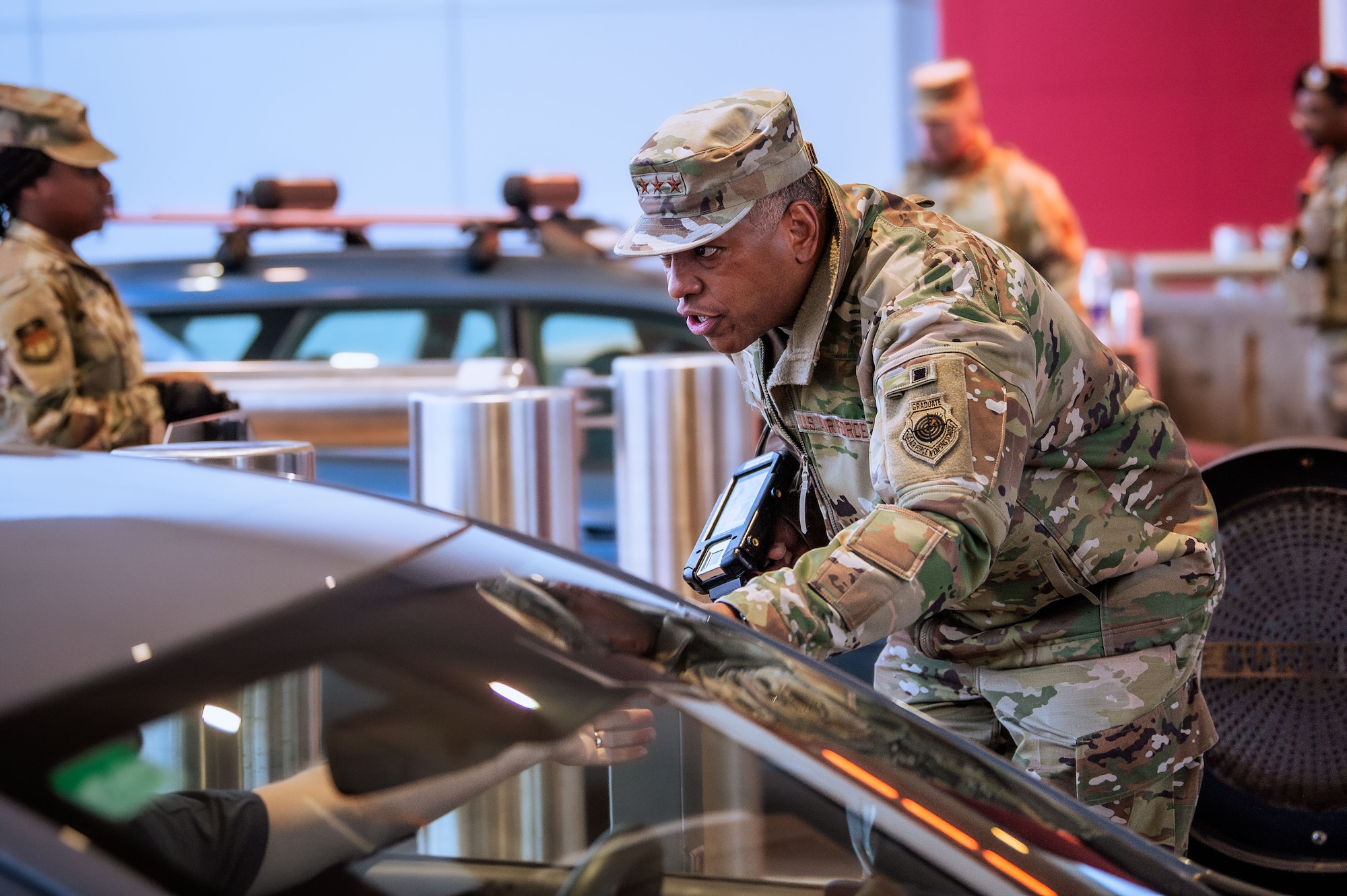 Superintendent Lt. Gen. Richard Clark checks IDs at the U.S. Air Force Academy’s north gate