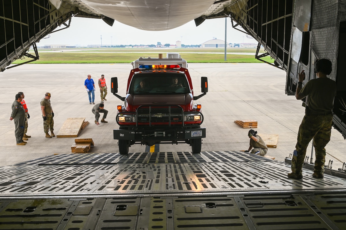SSgt. Jennifer Oveson, a 68th Airlift Squadron loadmaster, guides a vehicle from U.S. Army North’s Task Force 51 on to a 433rd Airlift Wing C-5M Super Galaxy as part of joint cargo upload training at Joint Base San Antonio-Lackland, Texas May 20, 2024.