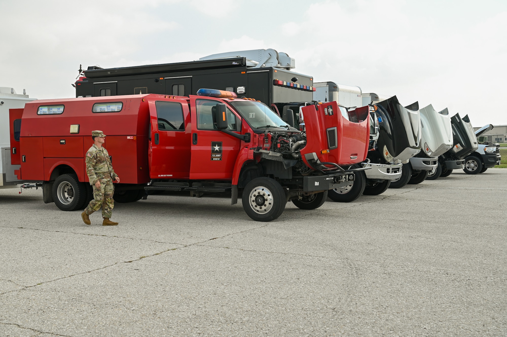 Five vehicles from U.S. Army North’s Task Force 51 are lined up for inspection as part of joint cargo upload training with the 433rd Airlift Wing at Joint Base San Antonio-Lackland, Texas Amy 20, 2024.