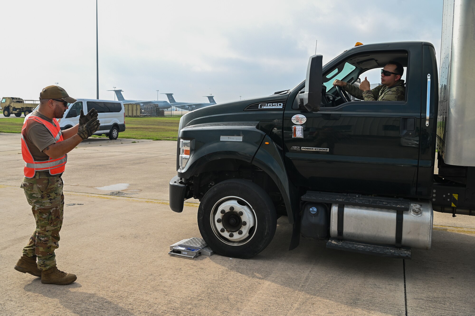 SSgt. Michael Therriat, a 733rd Training Squadron load plan representative, guides a Soldier from U.S. Army North’s Task Force 51 as he drives a box truck onto a scale as part of joint cargo upload training at Joint Base San Antonio-Lackland, Texas May 20, 2024.