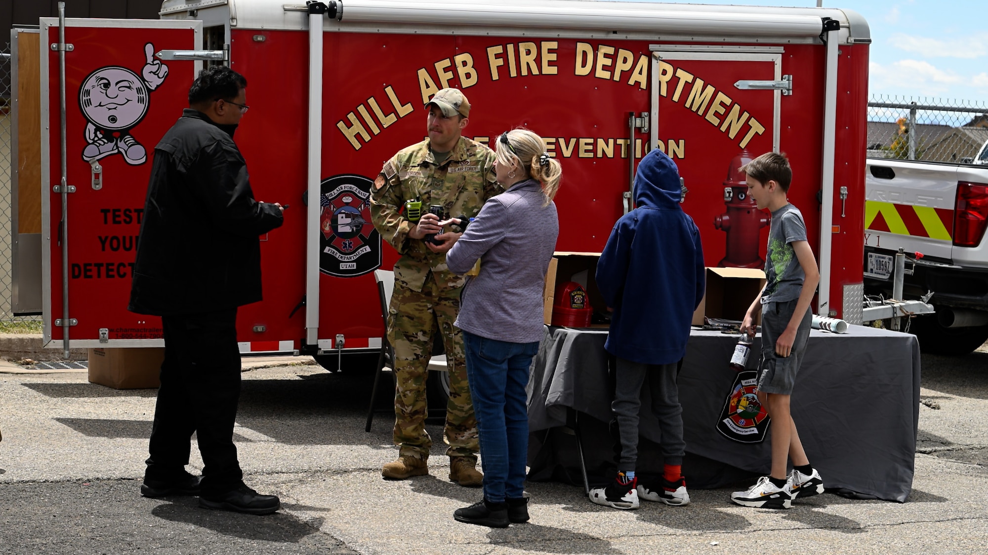 Staff Sgt. Daniel Gordon, Hill Fire and Emergency Services, speaks with attendees of a Safety Fest event at Hill Air Force Base, Utah, May 23, 2024. The event provided attendees an opportunity to learn about safety with live demonstrations, training and product exhibitions from more than 40 safety-related vendors. (U.S. Air Force photo by R. Nial Bradshaw)