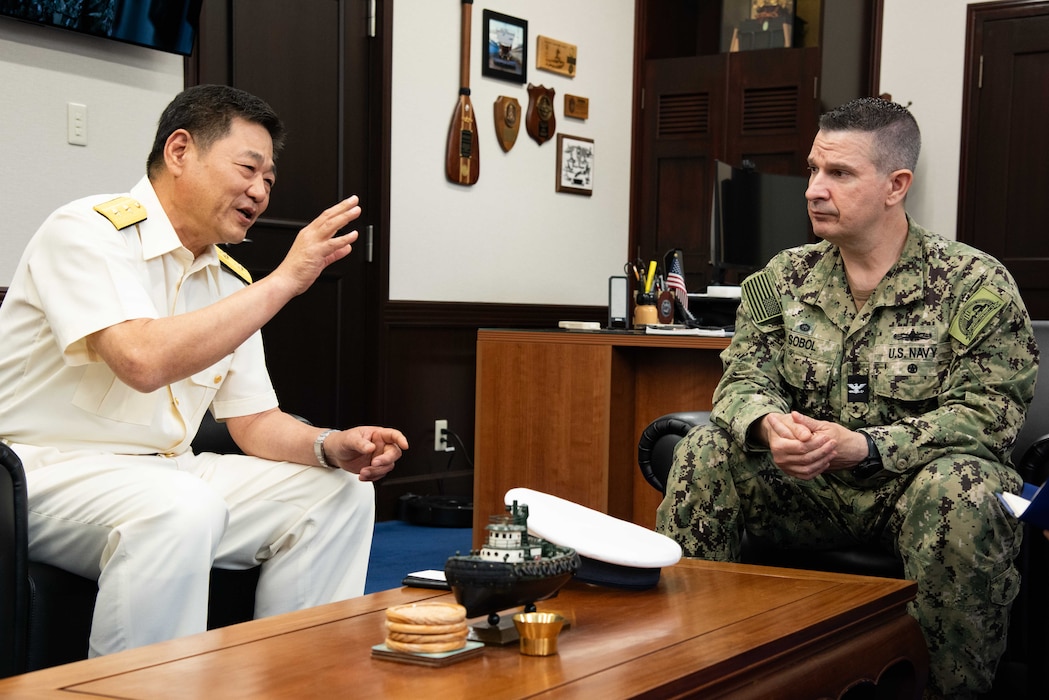 Rear Adm. Osamu Etani, chief, Yokosuka Coast Guard Office, and captain, the Port of Yokosuka, speaks with Capt. Les Sobol, Commander, Fleet Activities Yokosuka (CFAY) during an office call.