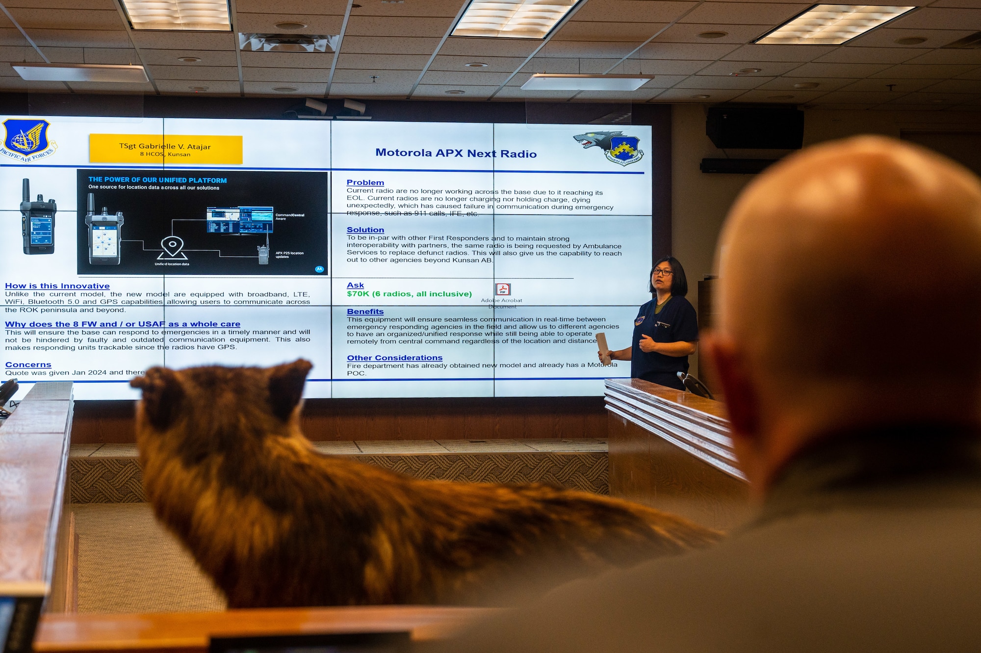 Tech Sgt. Gabrielle Atajar, 8th Healthcare Operations Squadron paramedic, presents her innovative idea to Col. Matthew Gaetke, 8th Fighter Wing commander, during a Wolfwerx event.