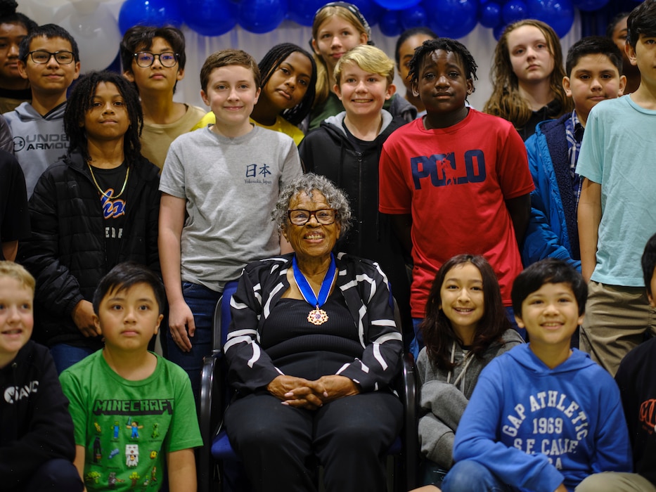 Dr. Opal Lee, the grandmother of Juneteenth and Presidential Medal of Freedom honoree, poses for a photo with students from Yokosuka Middle School May 20, 2024 at Commander, Fleet Activities Yokosuka.