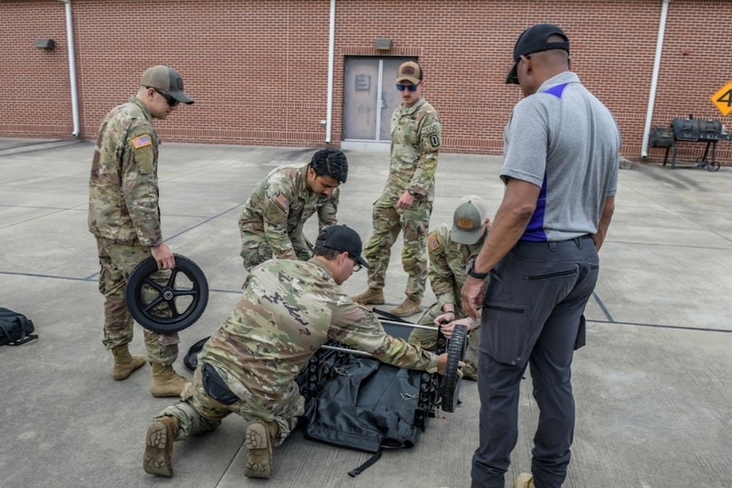 Soldiers put together a cart.