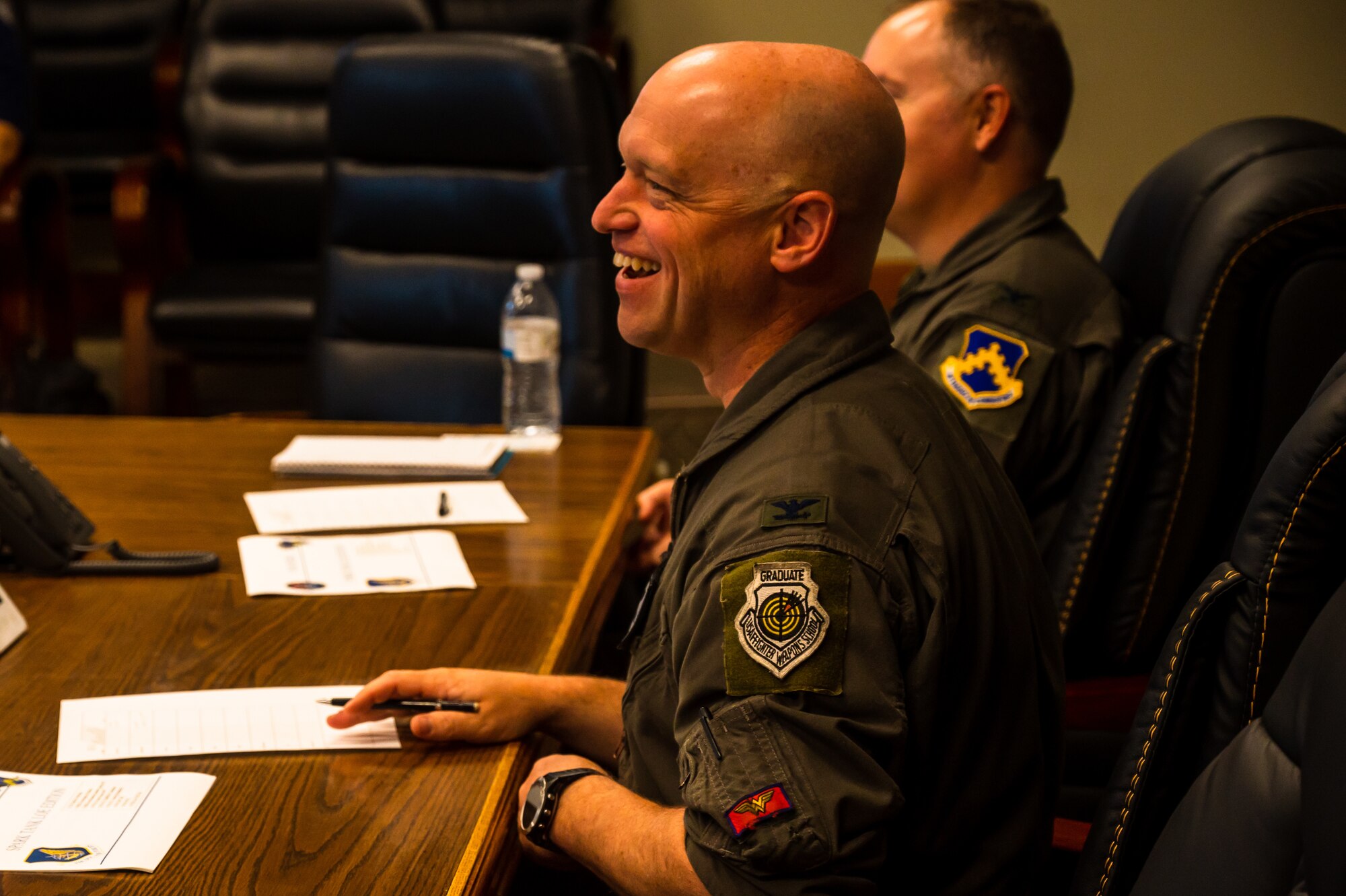 Col. Matthew Gaetke, 8th Fighter Wing commander, listens to innovative ideas from the Wolfwerx innovation team.