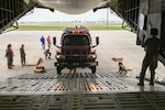SSgt. Jennifer Oveson, a 68th Airlift Squadron loadmaster, guides a vehicle from U.S. Army North’s Task Force 51 on to a 433rd Airlift Wing C-5M Super Galaxy as part of joint cargo upload training at Joint Base San Antonio-Lackland, Texas May 20, 2024.
