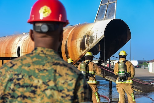 U.S. Marine Corps Master Gunnery Sgt. Terrail Dickerson, Marine Corps Detachment Goodfellow Air Force Base Fire Company senior enlisted advisor, observes a class of students as they practice C-130 burns on the training pad at Louis F. Garland Department of Defense Fire Academy on Goodfellow AFB, Texas, May 8, 2024. Dickerson let the moment soak in as he reflected on the fact that this would be his last time walking the training pad in his career. (U.S. Marine Corps photo by Cpl. Jessica Roeder)