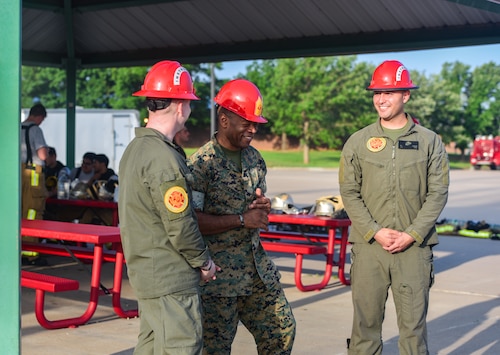 U.S. Marine Corps Master Gunnery Sgt. Terrail Dickerson, Marine Corps Detachment Goodfellow Air Force Base Fire Company senior enlisted advisor, speaks with Aircraft Rescue Firefighting block instructors at Louis F. Garland Department of Defense Fire Academy on Goodfellow AFB, Texas, May 8, 2024. Dickerson has moved duty stations every three years during his career which has kept him motivated as he is able to interact with a wide variety of people. (U.S. Marine Corps photo by Cpl. Jessica Roeder)
