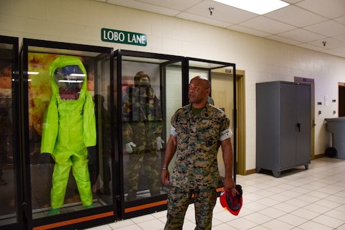 U.S. Marine Corps Master Gunnery Sgt. Terrail Dickerson, Marine Corps Detachment Goodfellow Air Force Base Fire Company senior enlisted advisor, looks over the various versions of personal protective equipment on display at the Louis F. Garland Department of Defense Fire Academy on Goodfellow AFB, Texas, May 8, 2024. Dickerson wants the history of the career field to be remembered but also reveled in the fact that versions of the equipment he had used are showcased like a museum exhibit. (U.S. Marine Corps photo by Cpl. Jessica Roeder)