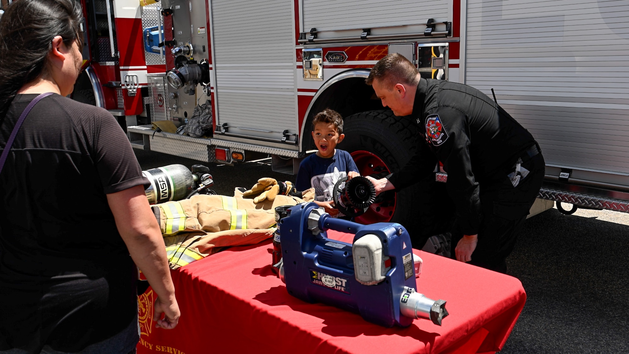 Laxiyah Moore looks at fire fighting equipment with Bryan Griffiths during a Safety Fest event at Hill Air Force Base, Utah, May 23, 2024. The event provided attendees an opportunity to learn about safety with live demonstrations, training and product exhibitions from more than 40 safety-related vendors. (U.S. Air Force photo by R. Nial Bradshaw)