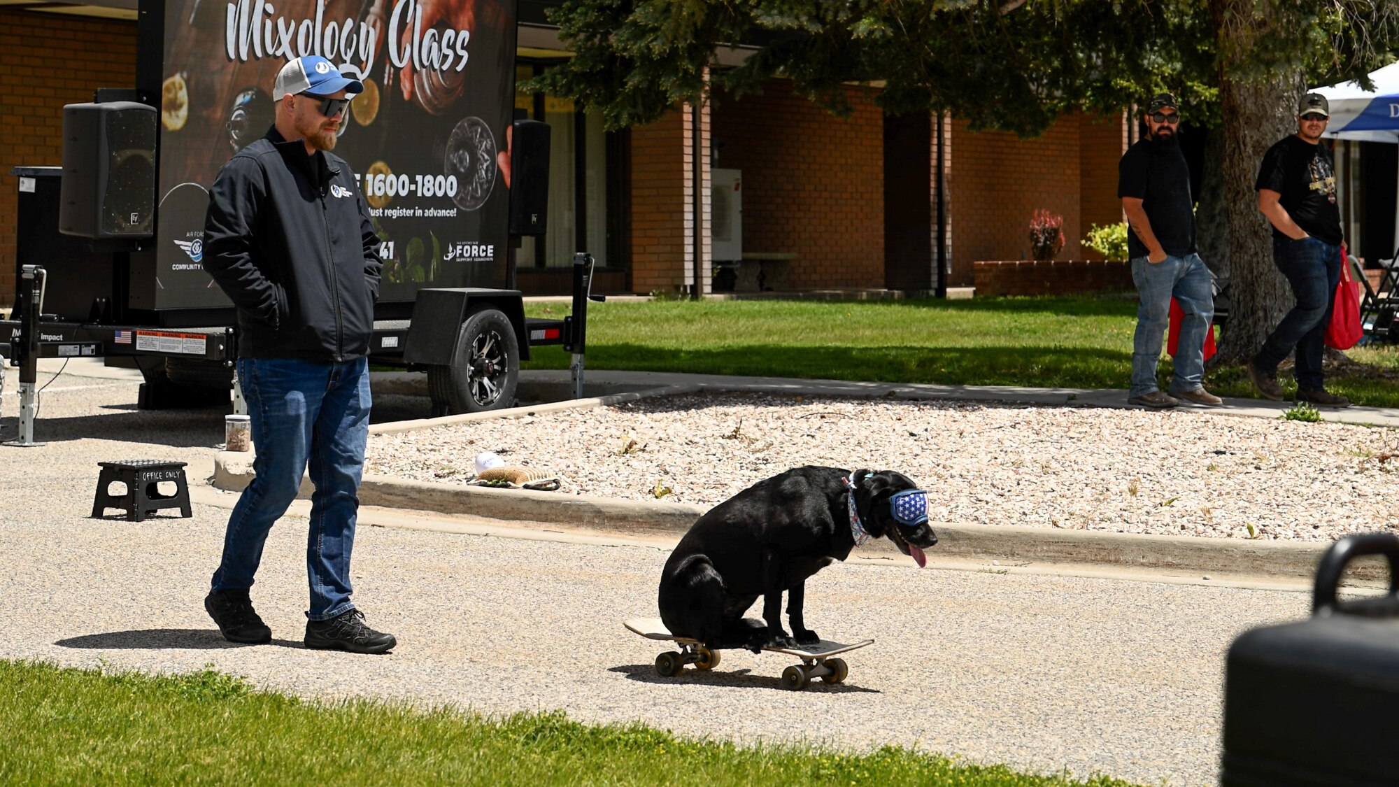 Dallin Renouard, Dog Training Elite, watches Lucy ride a skateboard during a Safety Fest demonstration at Hill Air Force Base, Utah, May 23, 2024. The event provided attendees an opportunity to learn about safety with live demonstrations, training and product exhibitions from more than 40 safety-related vendors. (U.S. Air Force photo by R. Nial Bradshaw)