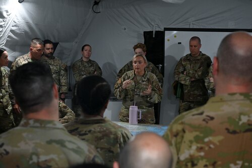 U.S. Air Force Technical Sgt. Renane Niemczyk, 313th Training Squadron contingency intelligence network section chief, briefs Visit-A-Palooza attendees on how the Joint All-Domain Expeditionary, Forward Operations Readiness Generation Exercise training site hosts training operations for current classes and future plans of expansion during Visit-A-Palooza, Goodfellow Air Force Base, May 2, 2024. Visit-A-Palooza brought 72 leaders from more than 40 units across the ISR enterprise to experience training operations the 17th Training Group has to offer students. (U.S. Air Force photo by Airman 1st Class Madison Collier)