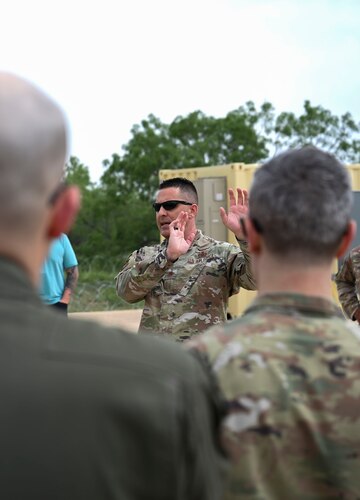 U.S. Air Force Maj. Christopher Perry, 313th Training Squadron director of operations, briefs Visit-A-Palooza attendees on the current state of operations at the Joint All-Domain Expeditionary, Forward Operations Readiness Generation Exercise training site, Goodfellow Air Force Base, May 2, 2024. The 17th Training Group welcomed senior leaders from across the Intelligence, Surveillance and Reconnaissance as well as Cybersecurity career fields to take a look at the current state of training, April 30 through May 2, providing attendees the opportunity to see the advancements made in intelligence training. (U.S. Air Force photo by Airman 1st Class Madison Collier)