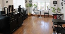 photo of area with seating and banquette with cereals, coffee, etc.
