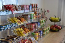 closeup of a variety of cereals, granola bars and fresh fruit