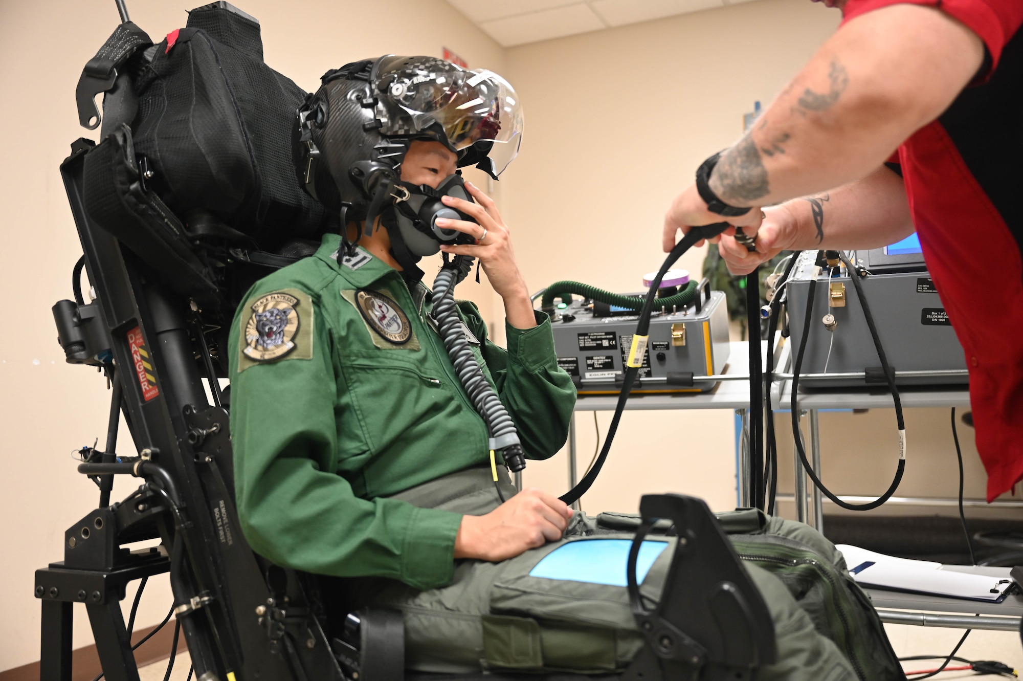 Capt. Ryosuke Sugimoto, a Japanese Air Self-Defense Force F-35 Lightning II pilot, tests his oxygen mask with the assistance of a fitter at the pilot fit facility on May 22, 2024.
