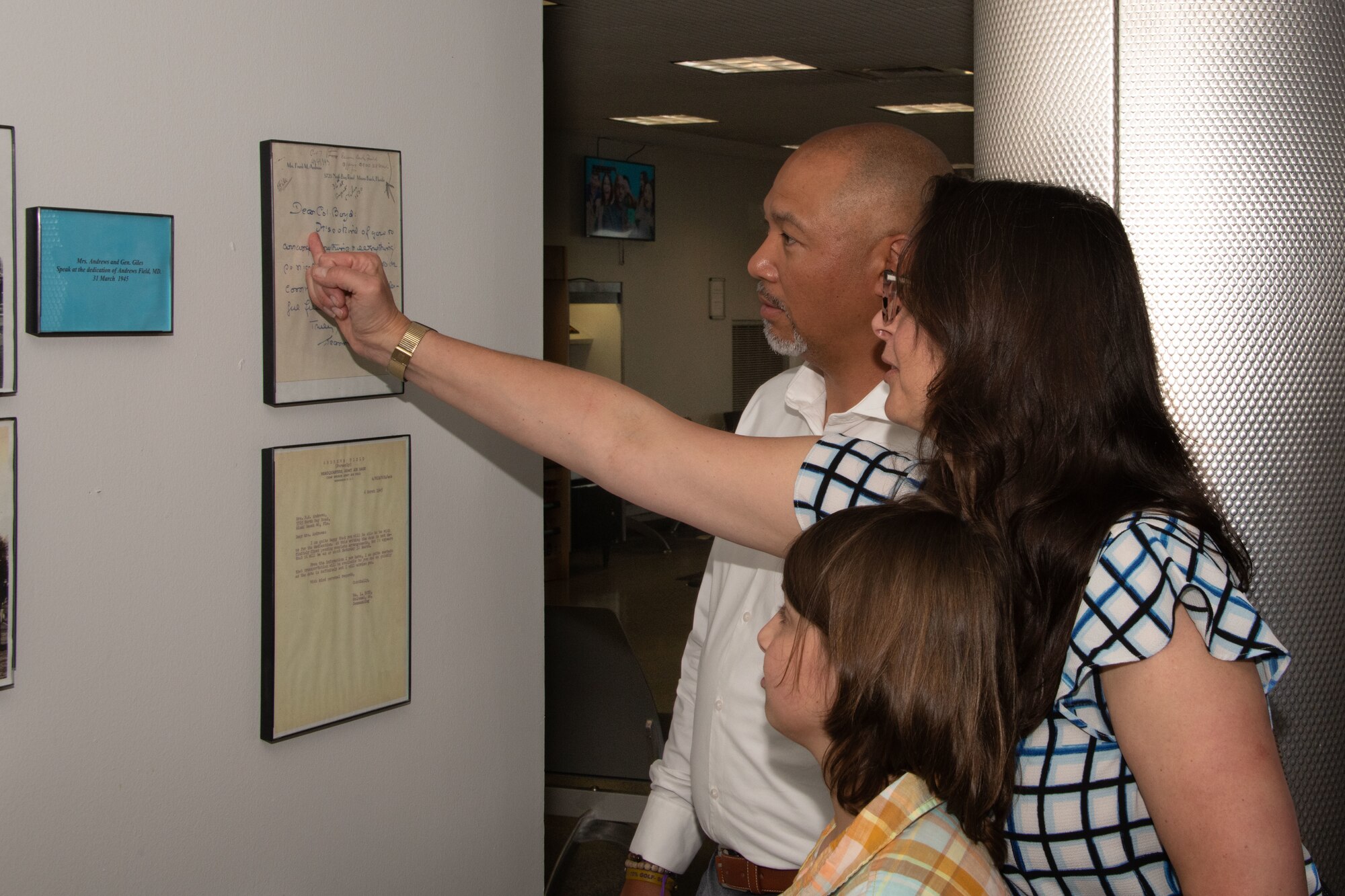 Family members of U.S. Army Lt. Gen. Frank M. Andrews look at a memorial display while on a tour at Joint Base Andrews, Md.