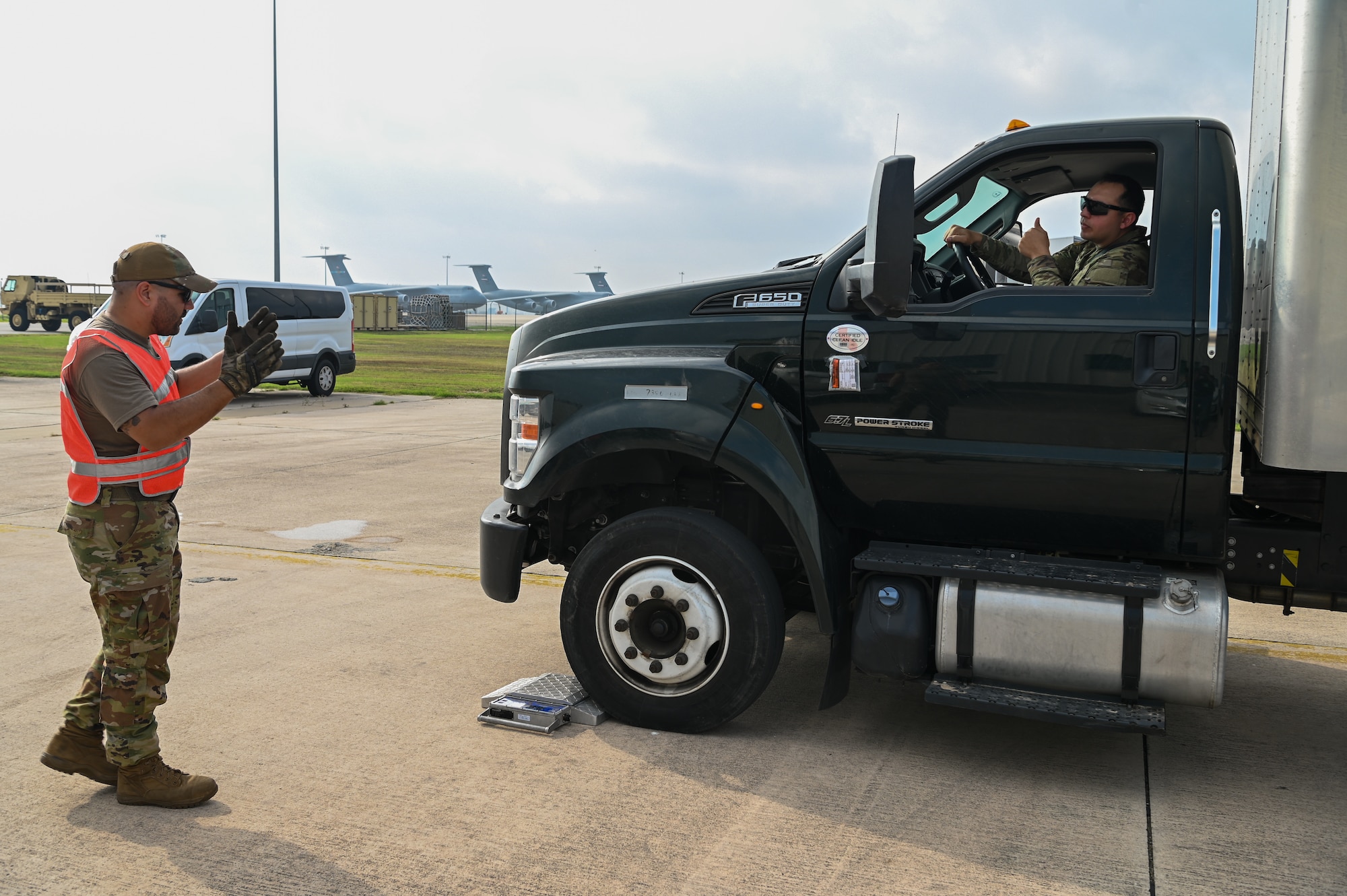 SSgt. Michael Therriat, a 733rd Training Squadron load plan representative, guides a Soldier from U.S. Army North’s Task Force 51 as he drives a box truck onto a scale as part of joint cargo upload training at Joint Base San Antonio-Lackland, Texas May 20, 2024.