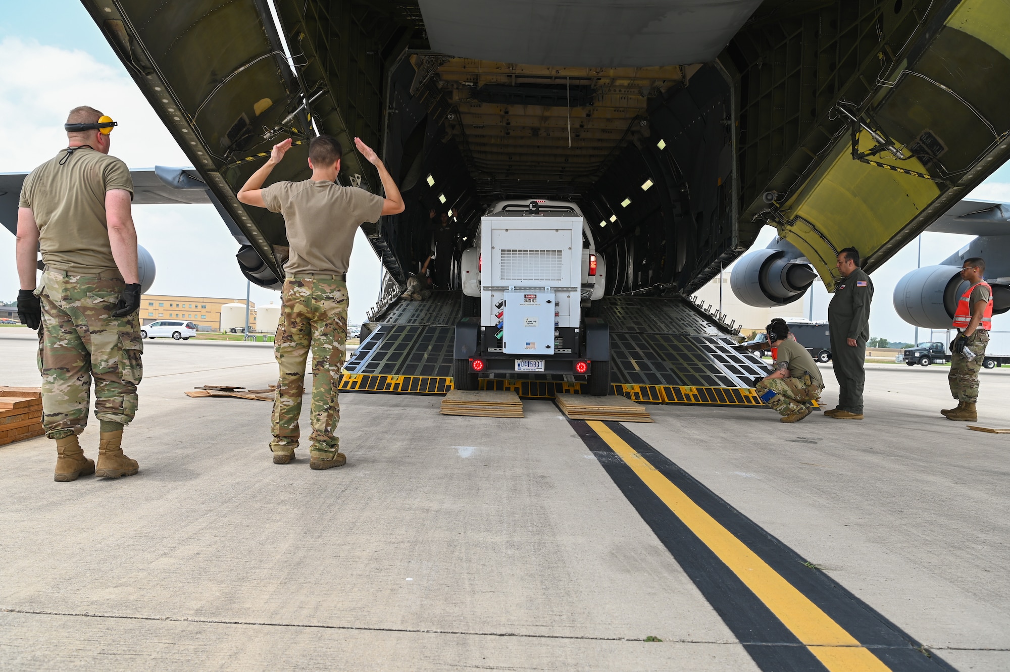 SSgt. Ethan Krempin, a 68th Airlift Squadron loadmaster, guides a vehicle from U.S. Army North’s Task Force 51 down the ramp of a 433rd Airlift Wing C-5M Super Galaxy as part of joint cargo upload training at Joint Base San Antonio-Lackland, Texas May 20, 2024.