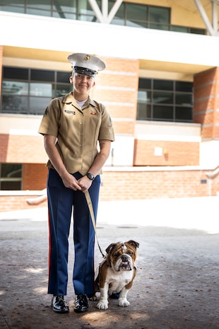 U.S. Marine Corps Cpl. Sarah Grawcock, a combat photographer and the mascot handler with Headquarters and Service Battalion, Marine Corps Recruit Depot San Diego, and Pfc. Bruno, the mascot of MCRD San Diego and the Western Recruiting Region, pose for a photo at Mira Costa High School, Manhattan Beach, California, during Los Angeles Fleet Week, May 21, 2024. LAFW is an opportunity for the American public to meet their Navy, Marine Corps and Coast Guard teams and experience America’s sea services. During fleet week, service members participate in various community service events, showcase capabilities and equipment to the community, and enjoy the hospitality of Los Angeles and its surrounding areas. (U.S. Marine Corps photo by Sgt. Yvonna Guyette)