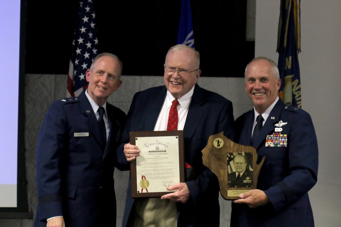 Maj. Gen. Don Dunbar, Wisconsin's adjutant general, and Brig. Gen. Gary Ebben, Wisconsin's deputy adjutant general for Air, present a Wisconsin Air National Guard Hall of Fame plaque and proclamation to retired Maj. Gen. Jerald D. Slack during a Sept. 5 induction ceremony at Volk Field. Wisconsin National Guard photo by Staff Sgt. Katie Eggers