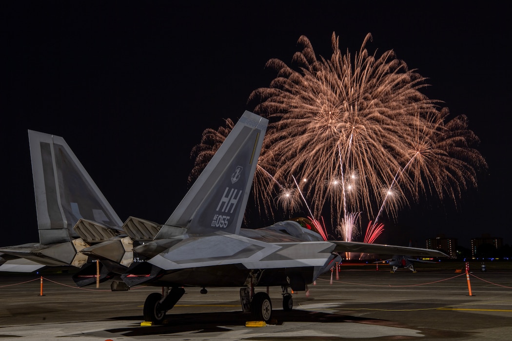 USAF F-22 Raptor sits on the flightline during fireworks display