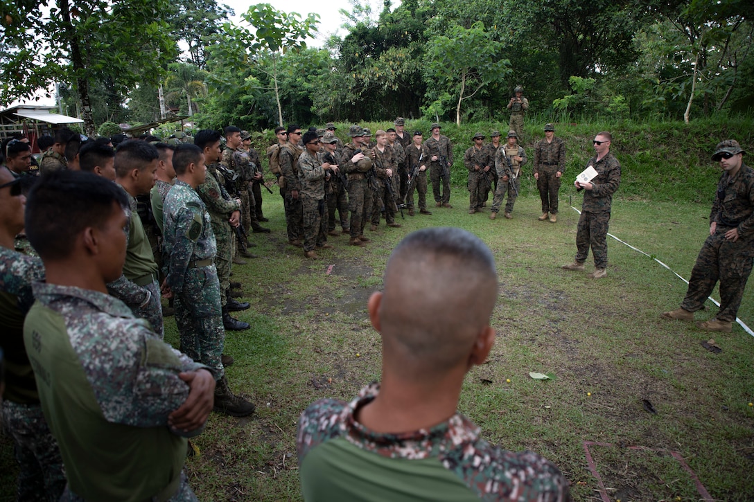 U.S. Marines with 1st Battalion, 7th Marine Regiment, 1st Marine Division, and service members of the Armed Forces of the Philippines, attend a range brief before close-quarters battle training during Archipelagic Coastal Defense Continuum in Barira, Philippines, May 20, 2024. ACDC is a series of bilateral exchanges and training opportunities between U.S. Marines and Philippine Marines aimed at bolstering the Philippine Marine Corps’ Coastal Defense strategy while supporting the modernization efforts of the Armed Forces of the Philippines. (U.S. Marine Corps photo by Cpl. Kayla Halloran)