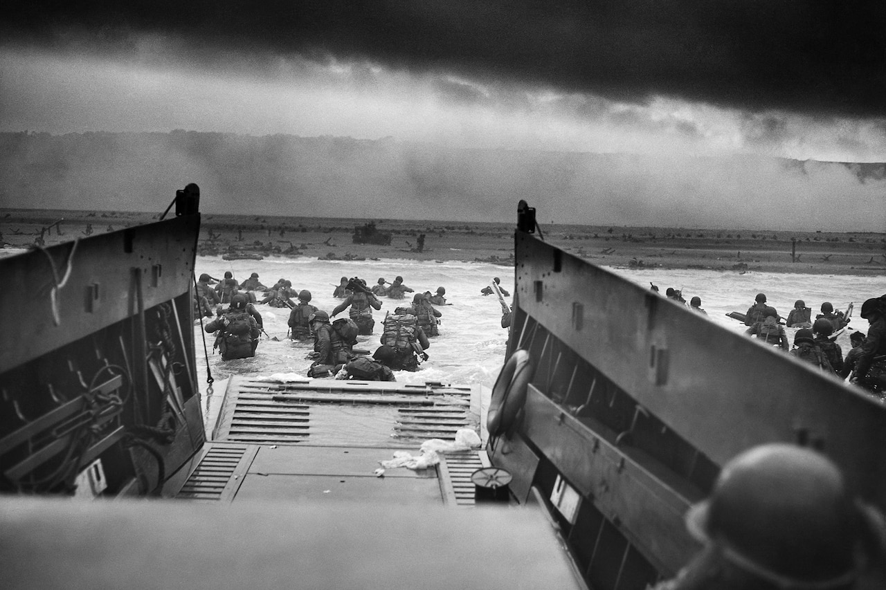 A watercraft unloads troops on a beach.