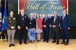 A group of smiling people on stage, men and women.