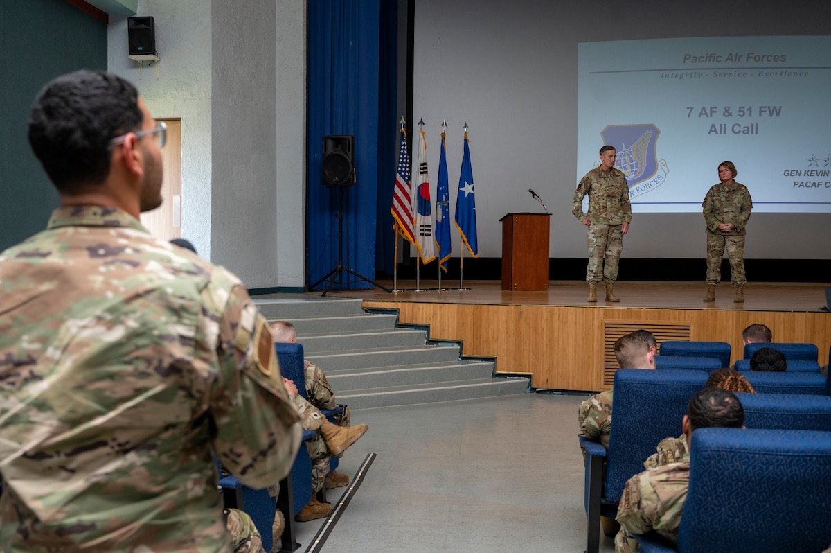 U.S. Air Force Gen. Kevin B. Schneider, Pacific Air Forces commander, and Chief Master Sgt. Kathleen McCool, PACAF command chief, answers questions at an all call during an immersion at Osan Air Base, Republic of Korea, May 23, 2024. While visiting, The PACAF command team shared their vision with base members on how to effectively meet future mission requirements. (U.S. Air Force photo by Senior Airman Sabrina Fuller-Judd)