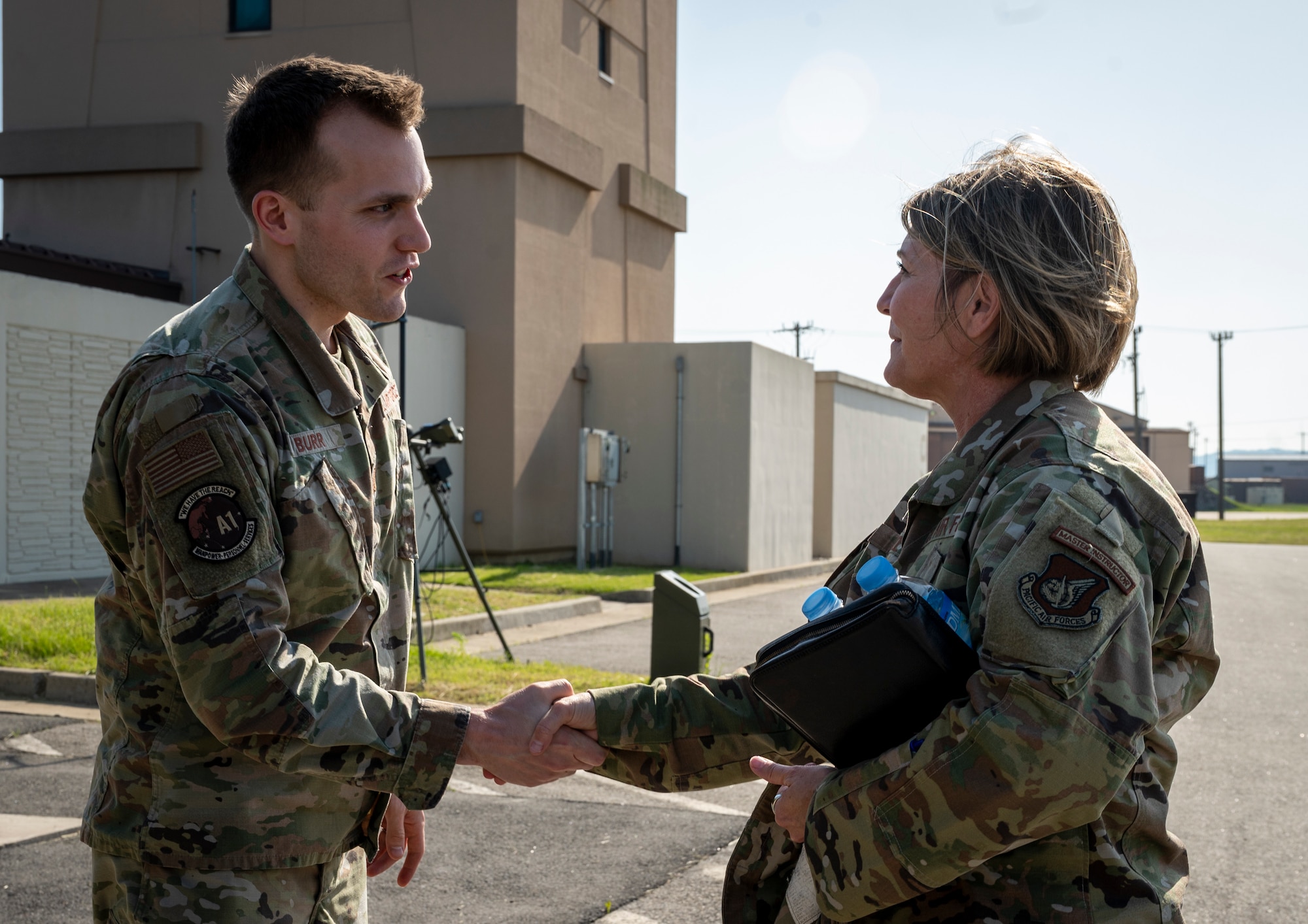 U.S. Air Force Chief Master Sgt. Kathleen McCool, Pacific Air Forces command chief, recognizes Capt. Sean Burr, 7th Air Force deputy director manpower, personnel and services, during an immersion at Osan Air Base, Republic of Korea, May 23, 2024. McCool recognized several Osan members for their contributions toward executing the mission and supporting Airmen. (U.S. Air Force photo by Senior Airman Sabrina Fuller-Judd)