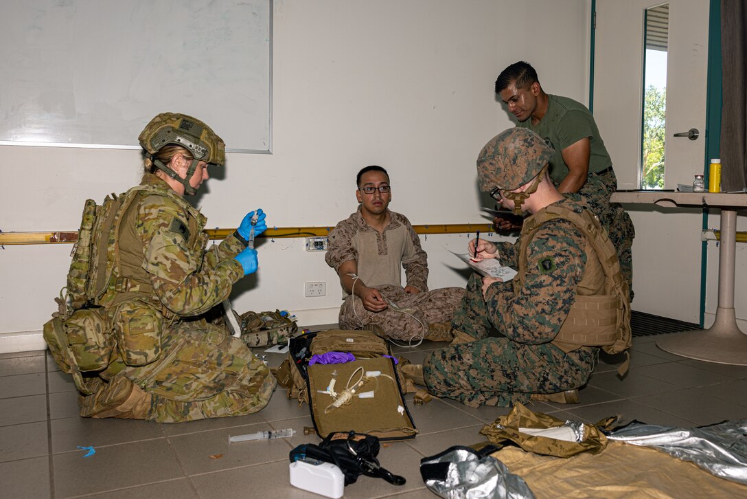 Australian Army PTE. Melissa Murray, left, a medical technician with 1st Health Battalion, 2nd Health Brigade, and Petty Officer 3rd Class Harrison Lawless, a hospital corpsman with Combat Logistics Battalion 5 (Reinforced), Marine Rotational Force – Darwin 24.3, draw blood during Valkyrie emergency fresh whole blood transfusion training at Robertson Barracks, Darwin, NT, Australia, May 17, 2024. The Valkyrie program enables military units to self-supply blood through emergency donor panels by adequate training, rehearsal, and preparation, gaining the skills and knowledge to efficiently collect whole blood, and conduct blood transfusions in the event of a casualty. Lawless is a native of Texas. (U.S. Marine Corps photo by Cpl. Juan Torres)