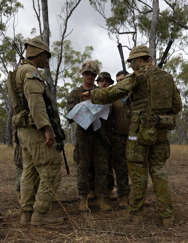 U.S. Marine Corps 1st Lt. Bryce Foxen, center, a company fire support officer with Golf Company, 2nd Battalion, 5th Marine Regiment (Reinforced), Marine Rotational Force – Darwin 24.3, plan movements with Australian Army PTE. Matthew Gregory, left, a forward observer, and Lt. Genevieve Butler both with 106th Battery, 4th Regiment, Royal Australian Artillery, 3rd Brigade, during Exercise Southern Jackaroo 24 at Townsville Field Training Area, Queensland, Australia, May 25, 2024. Members of MRF-D 24.3 deployed to TFTA to participate in Exercise Southern Jackaroo 24, a multilateral combined arms exercise held with capabilities and personnel from the Australian Army, U.S. Army and Marine Corps, Papua New Guinea Defence Force, and the Japanese Ground Self-Defense Force to increase interoperability with Allies and partners. Foxen is a native of Iowa. (U.S. Marine Corps photo by Cpl. Earik Barton)