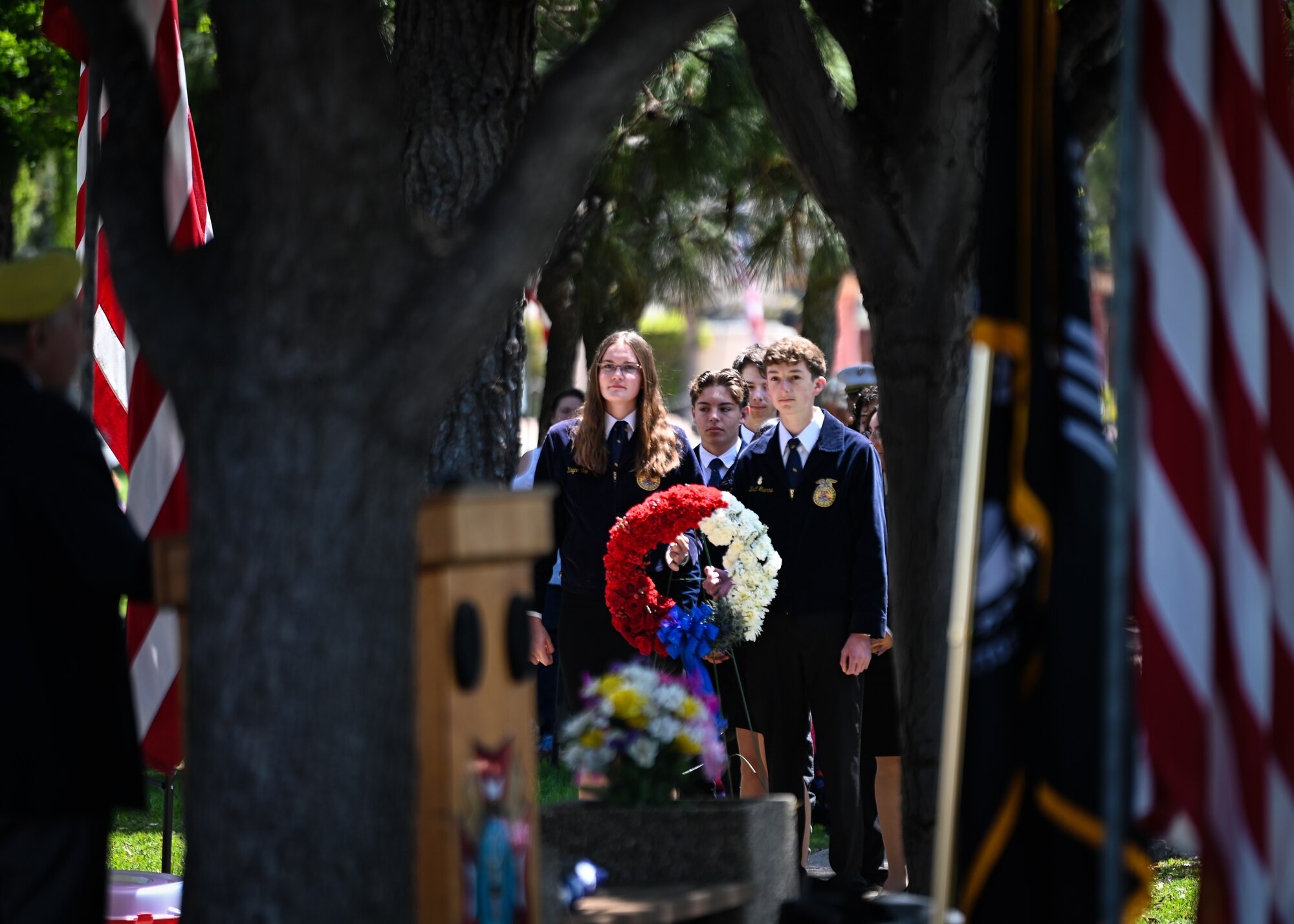 Teenagers wait to present a wreath.