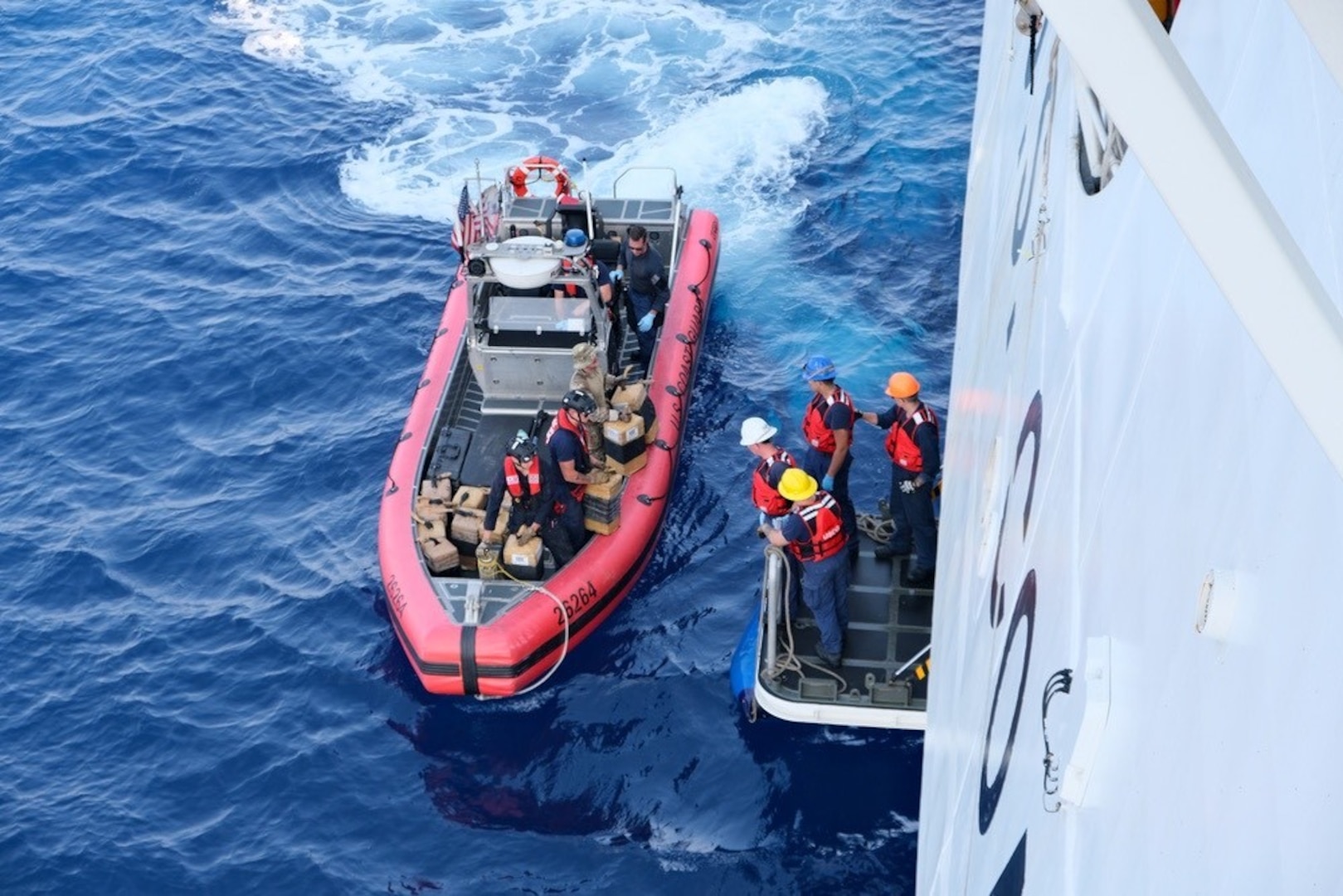 The crew of the Coast Guard Cutter Munro transfers bales of cocaine seized from a go-fast vessel in the Eastern Pacific Ocean, March 9, 2024. The Munro's crew have conducted counter-narcotic and counter illegal, unregulated and unreported (IUU) fishing patrols during their deployment. (U.S. Coast Guard photo by USCGC Munro/released)