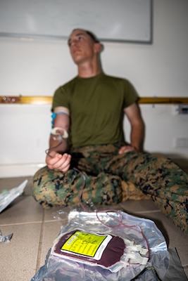 U.S. Marine Corps Lance Cpl. Christopher Parker, an intelligence specialist with 2nd Battalion, 5th Marine Regiment (Reinforced), Marine Rotational Force – Darwin 24.3, gets blood drawn during Valkyrie emergency fresh whole blood transfusion training at Robertson Barracks, Darwin, NT, Australia, May 17, 2024. The Valkyrie program enables military units to self-supply blood through emergency donor panels by adequate training, rehearsal, and preparation, gaining the skills and knowledge to efficiently collect whole blood, and conduct blood transfusions in the event of a casualty. Parker is a native of Virginia. (U.S. Marine Corps photo by Cpl. Juan Torres)