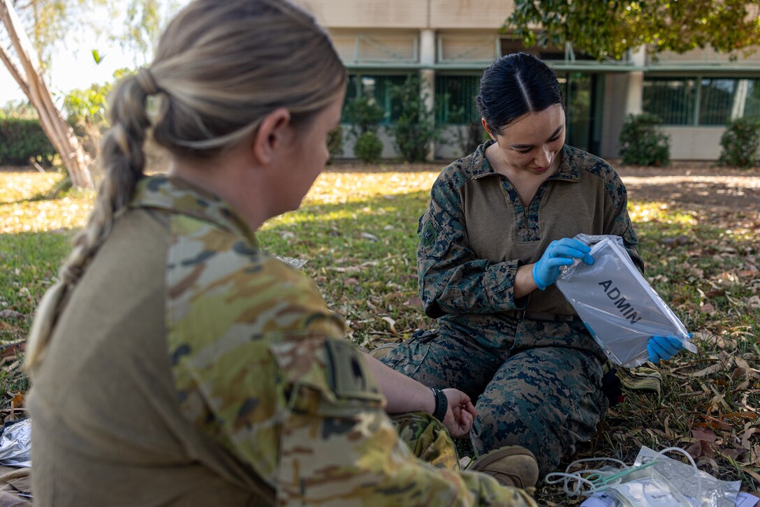 Australian Army PTE. Melissa Murray, left, a medical technician with 1st Health Battalion, 2nd Health Brigade, and U.S. Navy Petty Officer 3rd Class Ariana Buckley, a hospital corpsman with Combat Logistics Battalion 5 (Reinforced), Marine Rotational Force – Darwin 24.3, organize medical equipment during Valkyrie emergency fresh whole blood transfusion training at Robertson Barracks, Darwin, NT, Australia, May 16, 2024. The Valkyrie program enables military units to self-supply blood through emergency donor panels by adequate training, rehearsal, and preparation, gaining the skills and knowledge to efficiently collect whole blood, and conduct blood transfusions in the event of a casualty. Buckley is a native of New York. (U.S. Marine Corps photo by Cpl. Juan Torres)