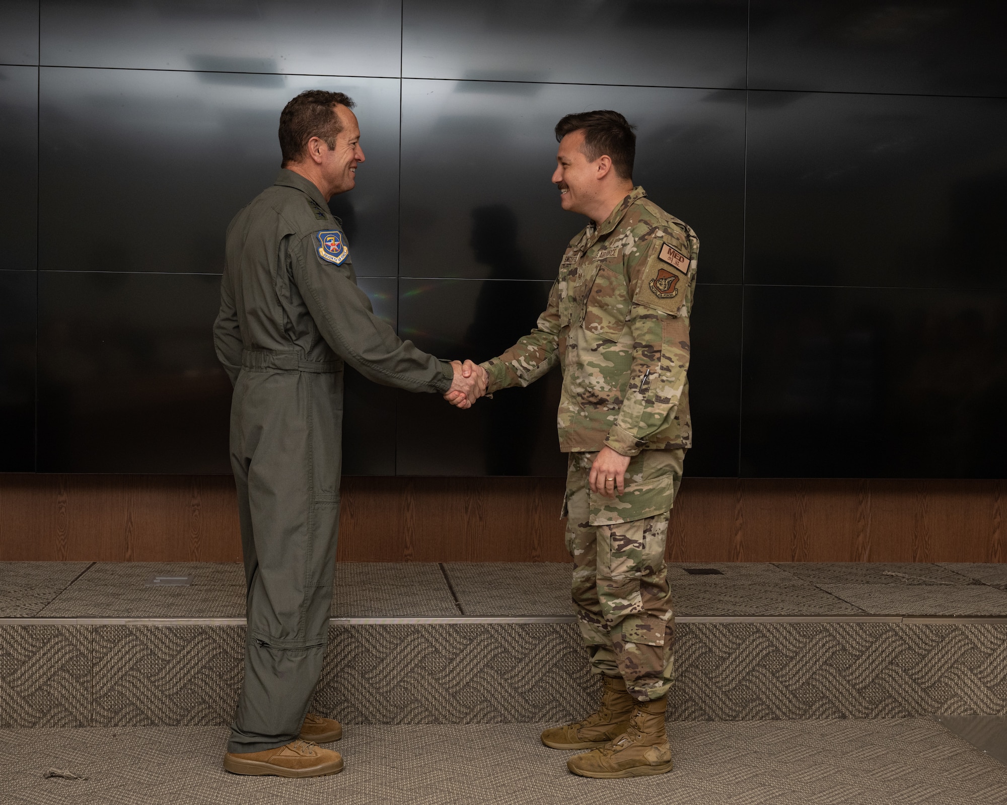 Lt. Gen. David Iverson, left, 7th Air Force commander, coins Staff Sgt. James Singleton, 8th Medical Group client support non-commissioned officer in charge, at Kunsan Air Base, Republic of Korea.